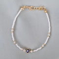 Bracelet fantaisie perles blanches et dorées œil